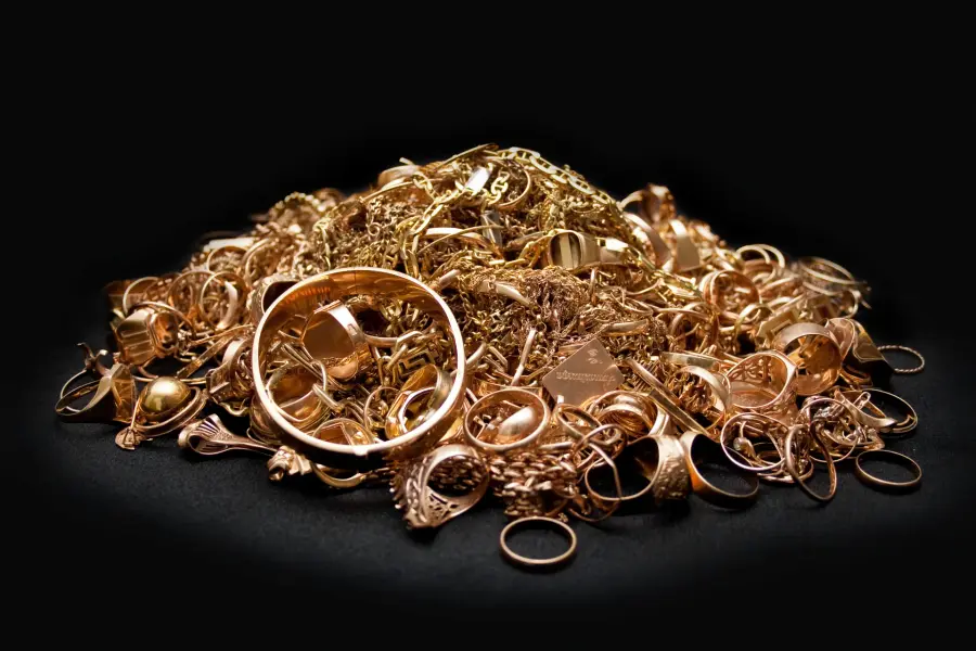 A pile of gold jewelry, rings, and chains