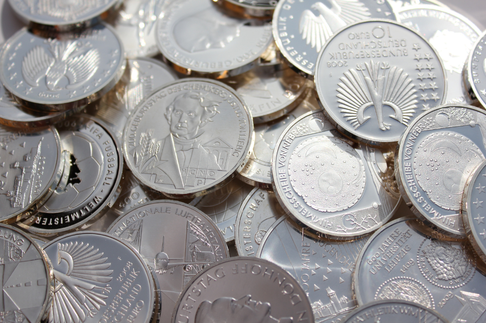 Assorted silver commemorative coins with detailed engravings – Coin Buyers in Tyler.